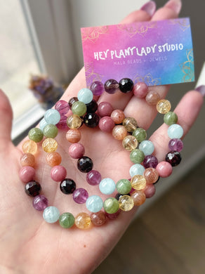 Ostara - 8mm Garnet, Rhodonite, Sunstone, Citrine, Green Apatite, Aquamarine, Purple Fluorite, Smoky Quartz Gemstone Stretch Mala Bracelet