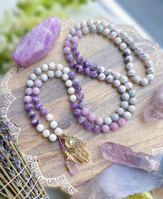 Load image into Gallery viewer, Angelic Guidance - Kunzite, Jade, Dream Amethyst, Mother of Pearl, &amp; Howlite 108 Mala Bead Necklace - 24k Gold Overlay Hamsa + 24K Gold Aura Quartz